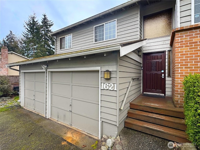 view of exterior entry with an attached garage