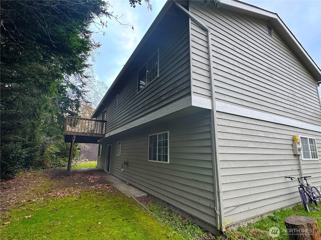 view of home's exterior with a wooden deck