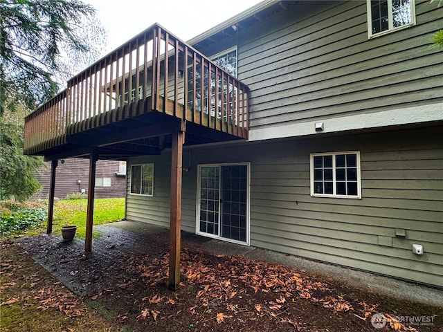 rear view of property featuring a wooden deck