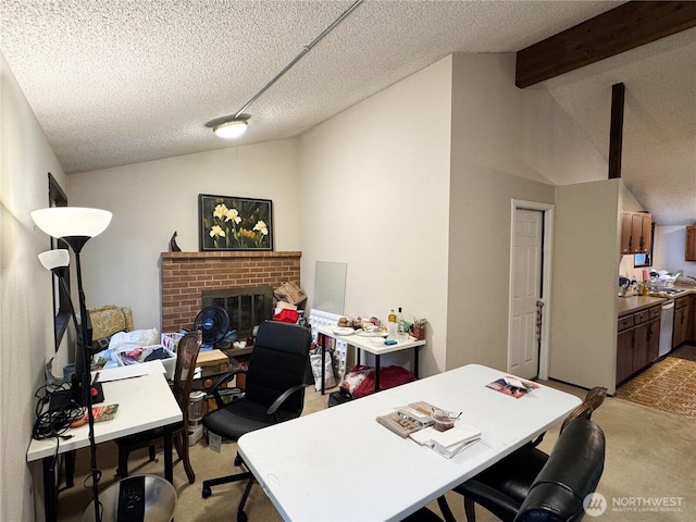 office area featuring lofted ceiling with beams, light colored carpet, a brick fireplace, and a textured ceiling