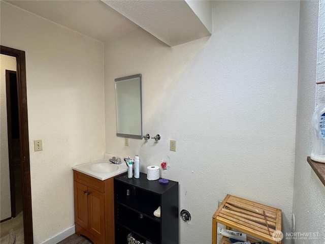 bathroom featuring vanity and baseboards