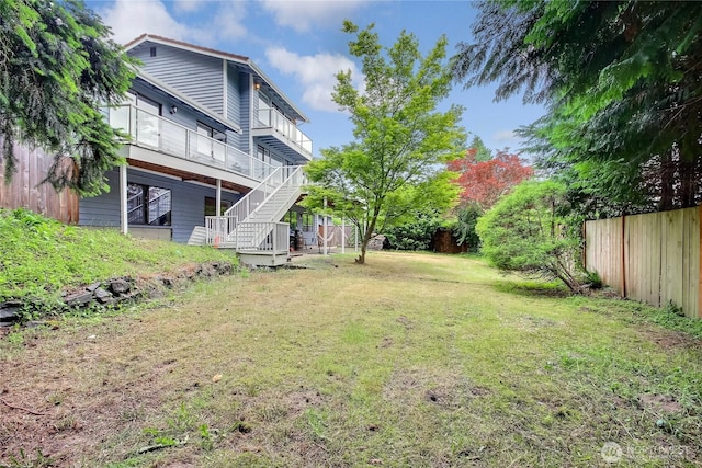 view of yard with stairway and fence