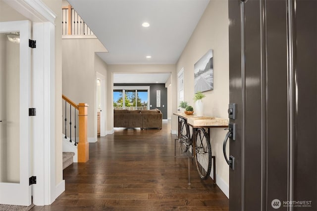 corridor with stairway, recessed lighting, dark wood-style floors, and baseboards