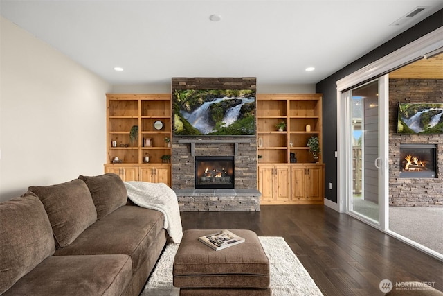 living room featuring recessed lighting, a fireplace, dark wood-type flooring, and baseboards