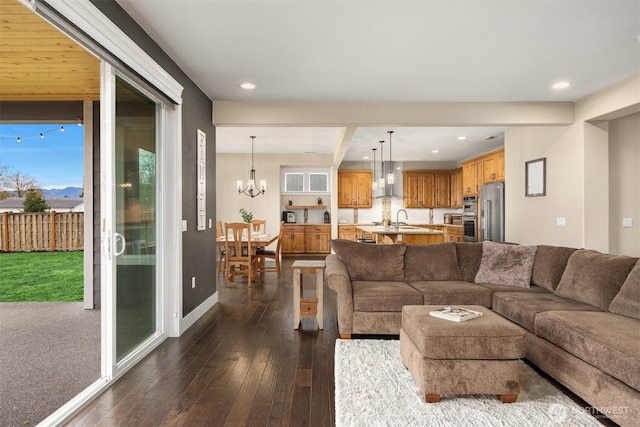 living area featuring an inviting chandelier, dark wood-type flooring, recessed lighting, and baseboards