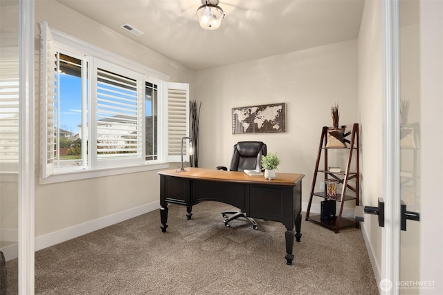 carpeted home office with visible vents and baseboards