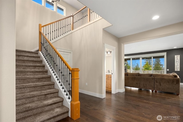 staircase with recessed lighting, baseboards, and wood-type flooring