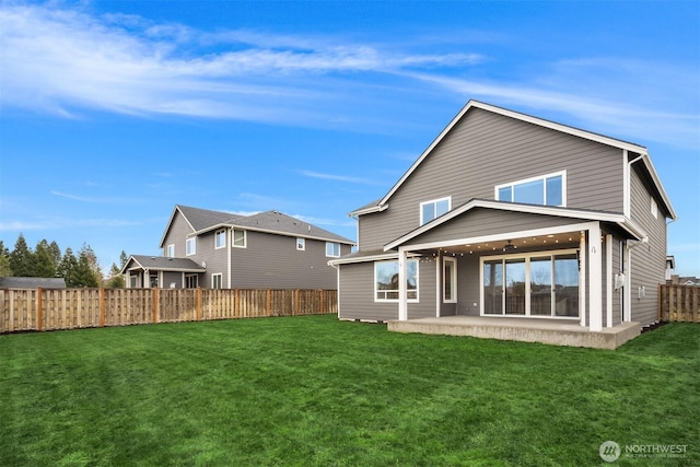 rear view of property with a lawn, a patio, a fenced backyard, and ceiling fan