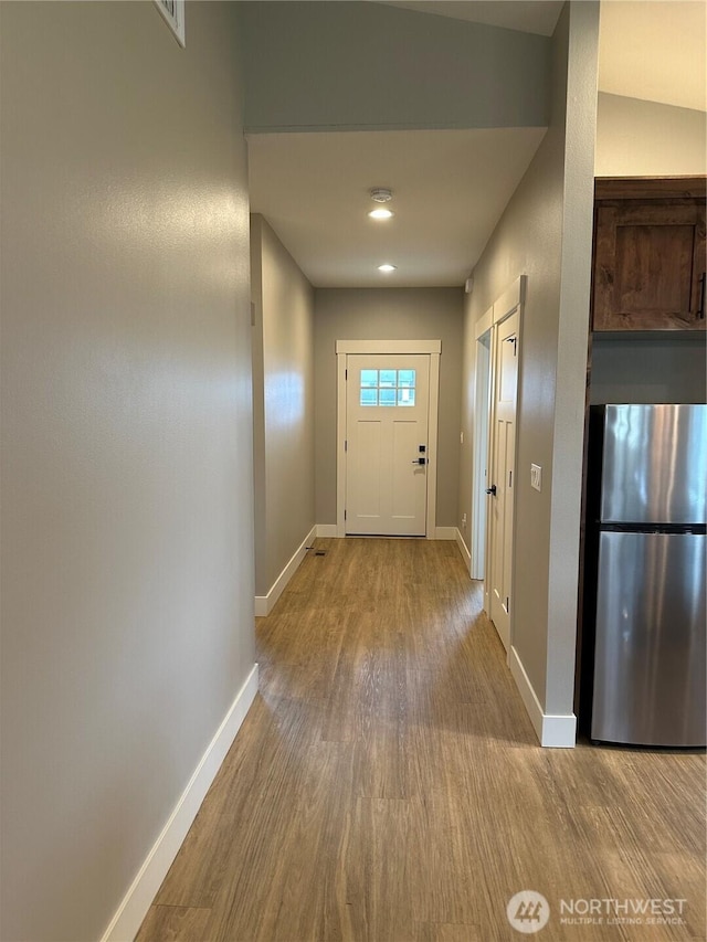 entryway featuring baseboards and wood finished floors