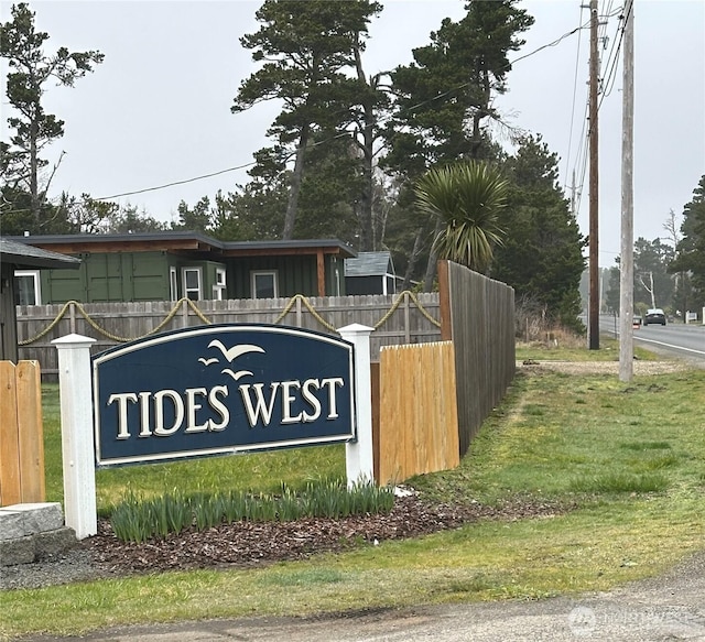 community sign featuring fence