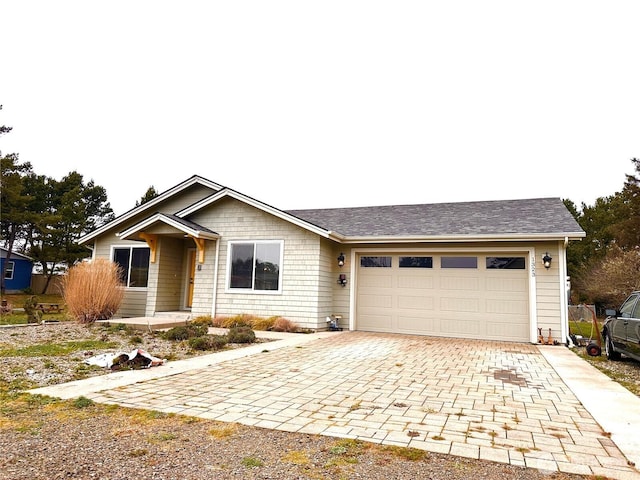 ranch-style house with decorative driveway and an attached garage