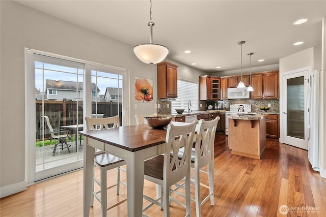 dining area featuring recessed lighting and light wood-style flooring