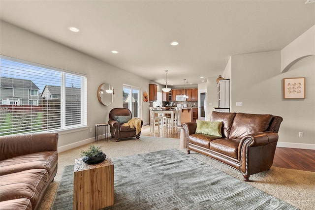 living room featuring wood finished floors, recessed lighting, and baseboards