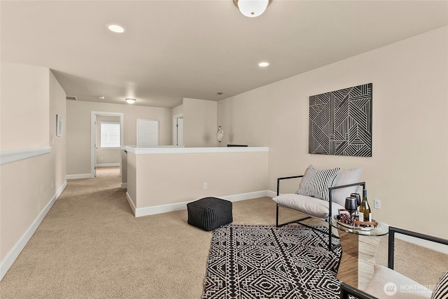 living area featuring light carpet, recessed lighting, and baseboards