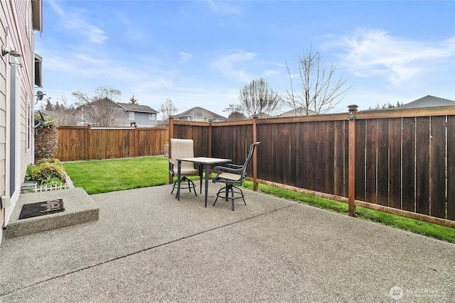 view of patio with outdoor dining area and a fenced backyard