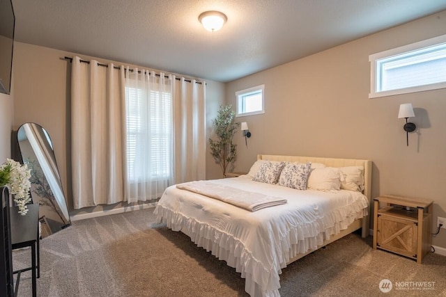 carpeted bedroom with a textured ceiling