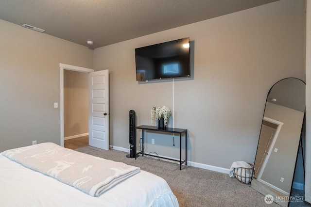 bedroom featuring baseboards, carpet floors, and visible vents