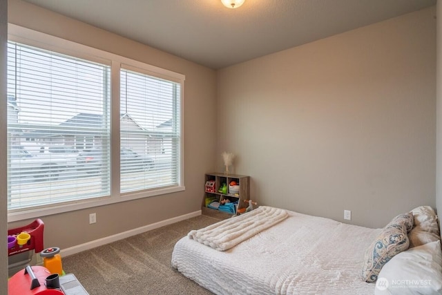 bedroom with baseboards and carpet flooring