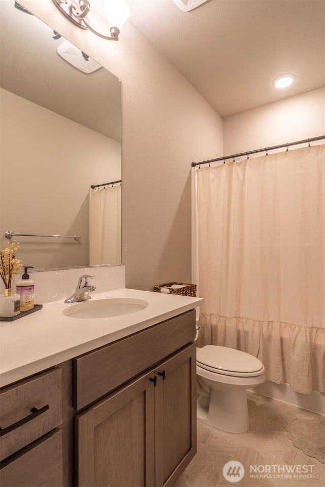 bathroom with recessed lighting, toilet, vanity, and shower / bath combination with curtain