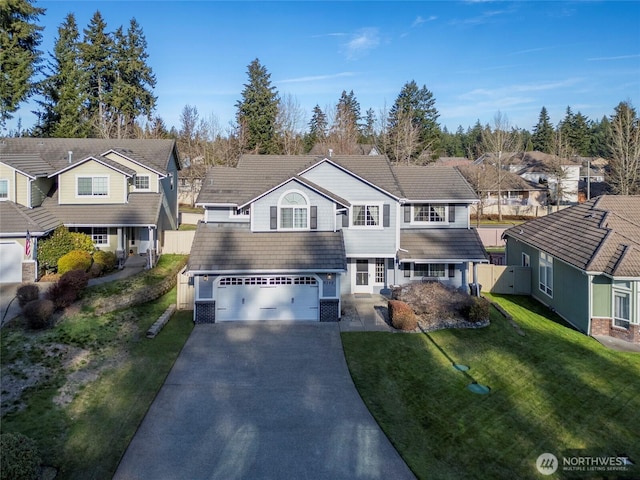 view of front of house with a residential view, a tile roof, a front yard, a garage, and driveway