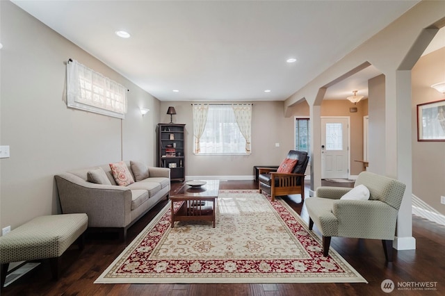 living area featuring recessed lighting, baseboards, and dark wood finished floors