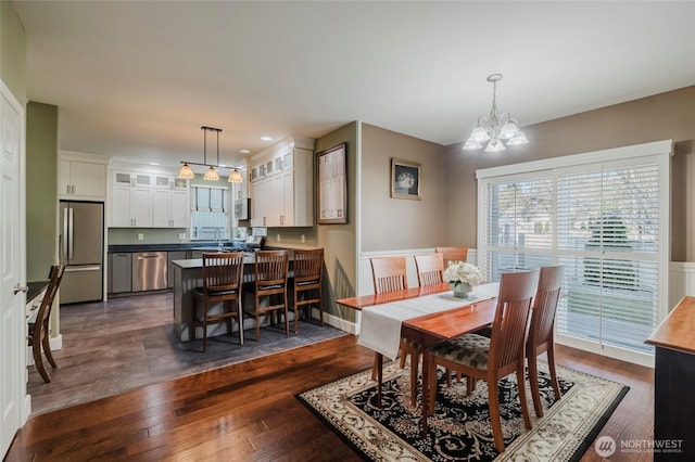 dining room with recessed lighting, an inviting chandelier, and dark wood-style flooring