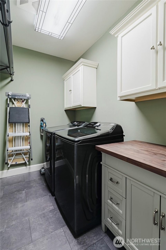 laundry area featuring visible vents, cabinet space, baseboards, and separate washer and dryer