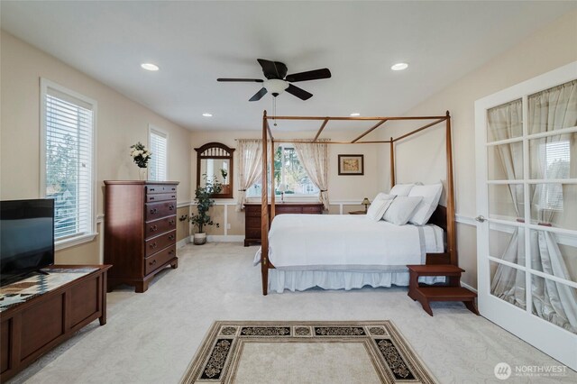 bedroom featuring light carpet, recessed lighting, and multiple windows