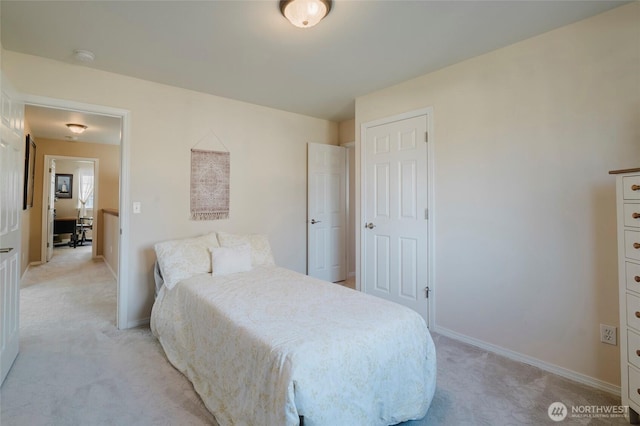 bedroom featuring baseboards and light carpet