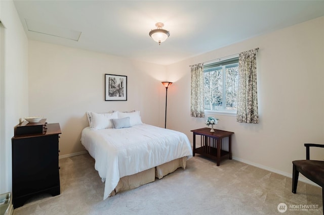 bedroom with light carpet, attic access, and baseboards