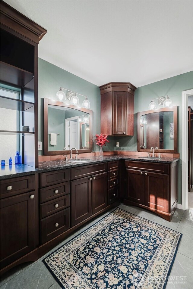 bathroom with tile patterned flooring and vanity