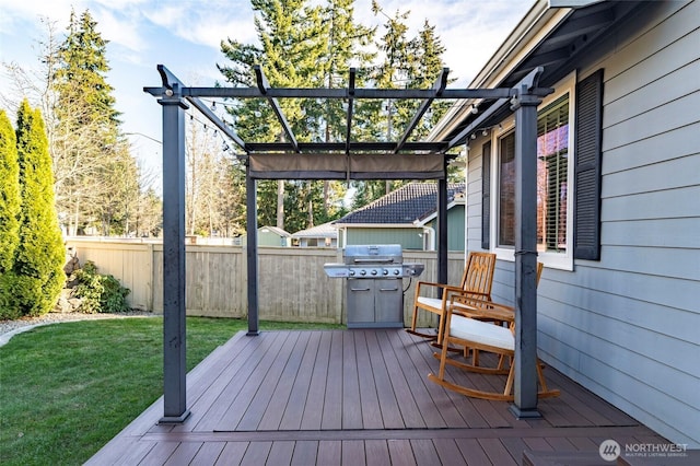 wooden terrace with a lawn, a pergola, and fence