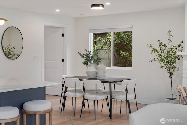 dining space with recessed lighting and light wood finished floors