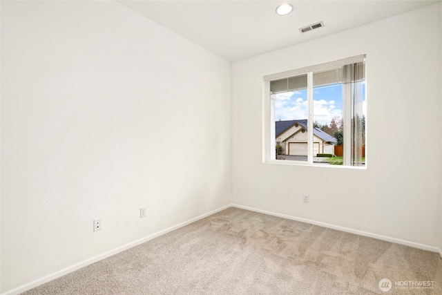 carpeted spare room with baseboards and visible vents