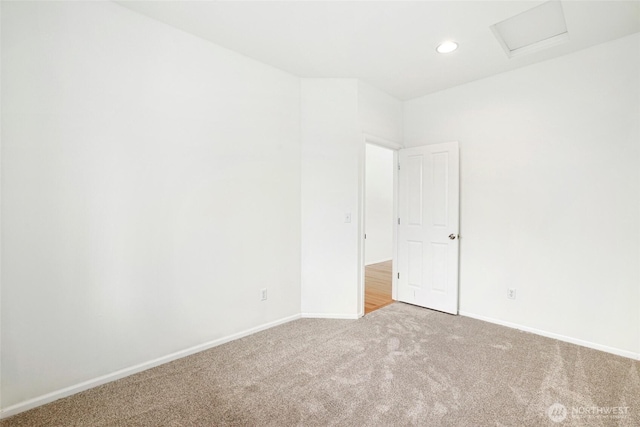 carpeted empty room with attic access, recessed lighting, and baseboards