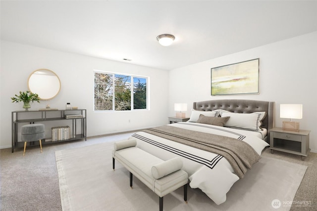 bedroom with visible vents, baseboards, and carpet