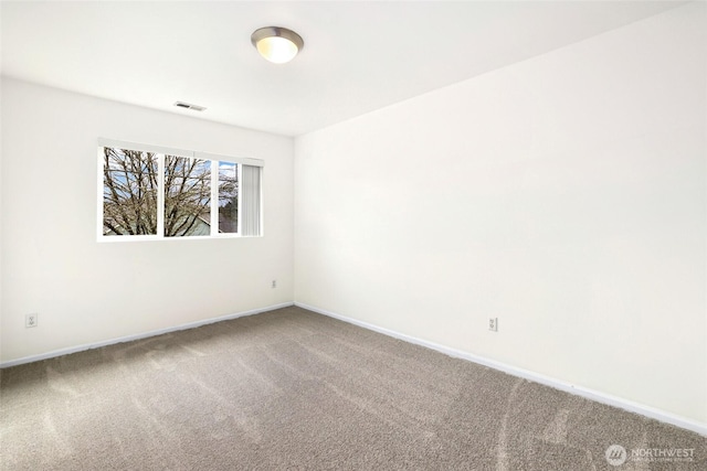 carpeted spare room with baseboards and visible vents