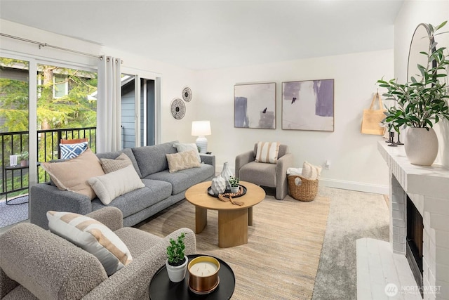 living area featuring a fireplace and baseboards