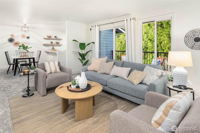 carpeted living area featuring baseboards