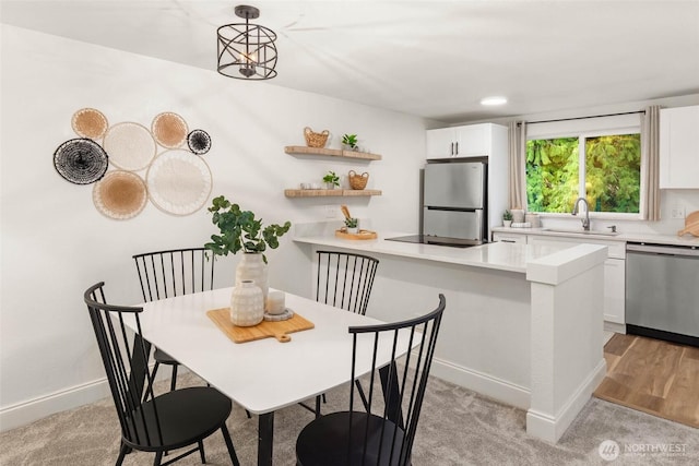 dining room with recessed lighting and baseboards