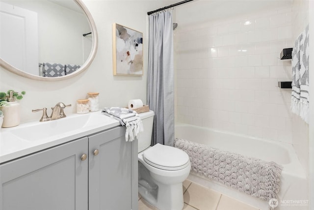 full bathroom featuring tile patterned flooring, vanity, toilet, and shower / bath combo with shower curtain