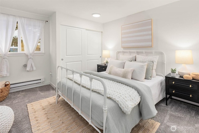 bedroom featuring a closet, carpet floors, and baseboard heating