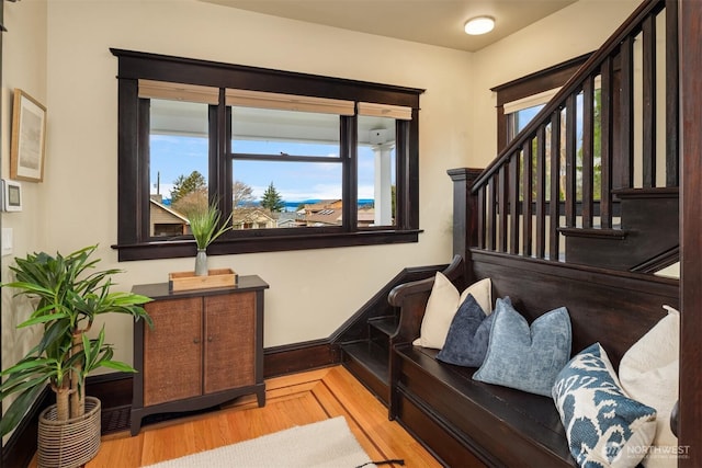 entrance foyer with stairs, wood finished floors, and baseboards