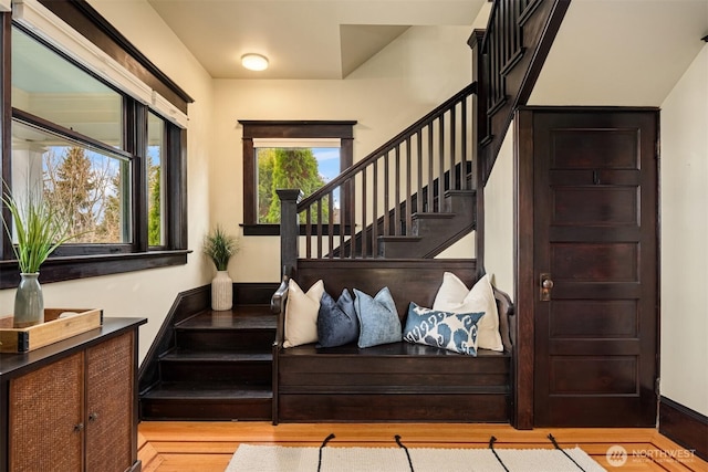 foyer entrance with stairway and wood finished floors