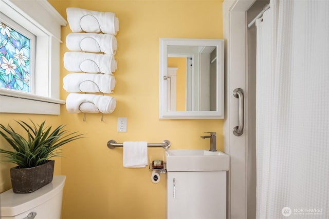 bathroom with a shower with curtain and toilet