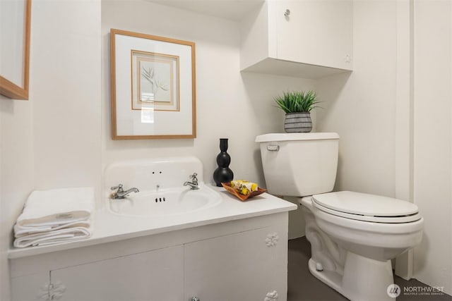 bathroom featuring vanity and toilet