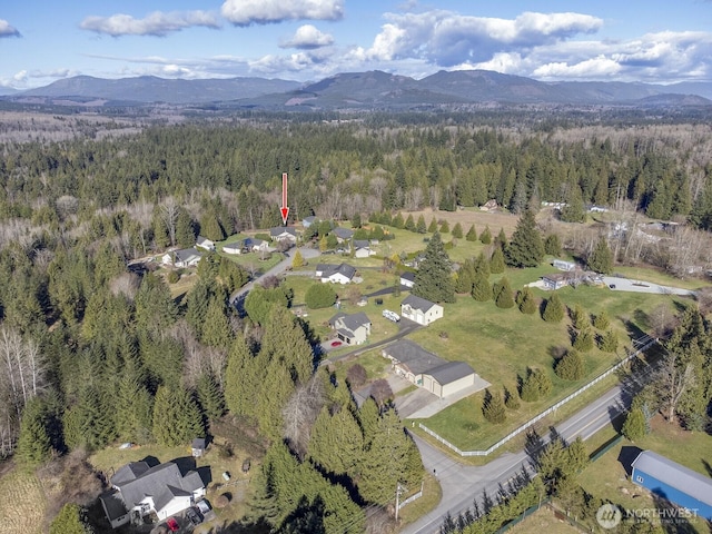 bird's eye view with a mountain view and a wooded view