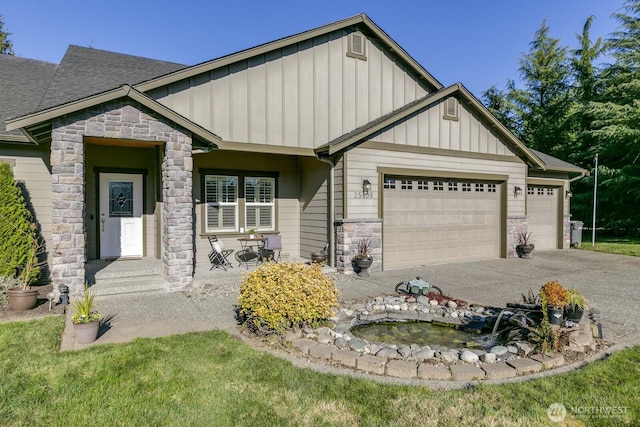 craftsman house featuring driveway, an attached garage, a shingled roof, stone siding, and board and batten siding