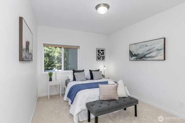 bedroom featuring light carpet and baseboards