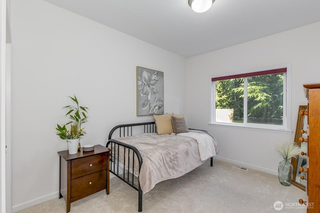 carpeted bedroom featuring visible vents and baseboards